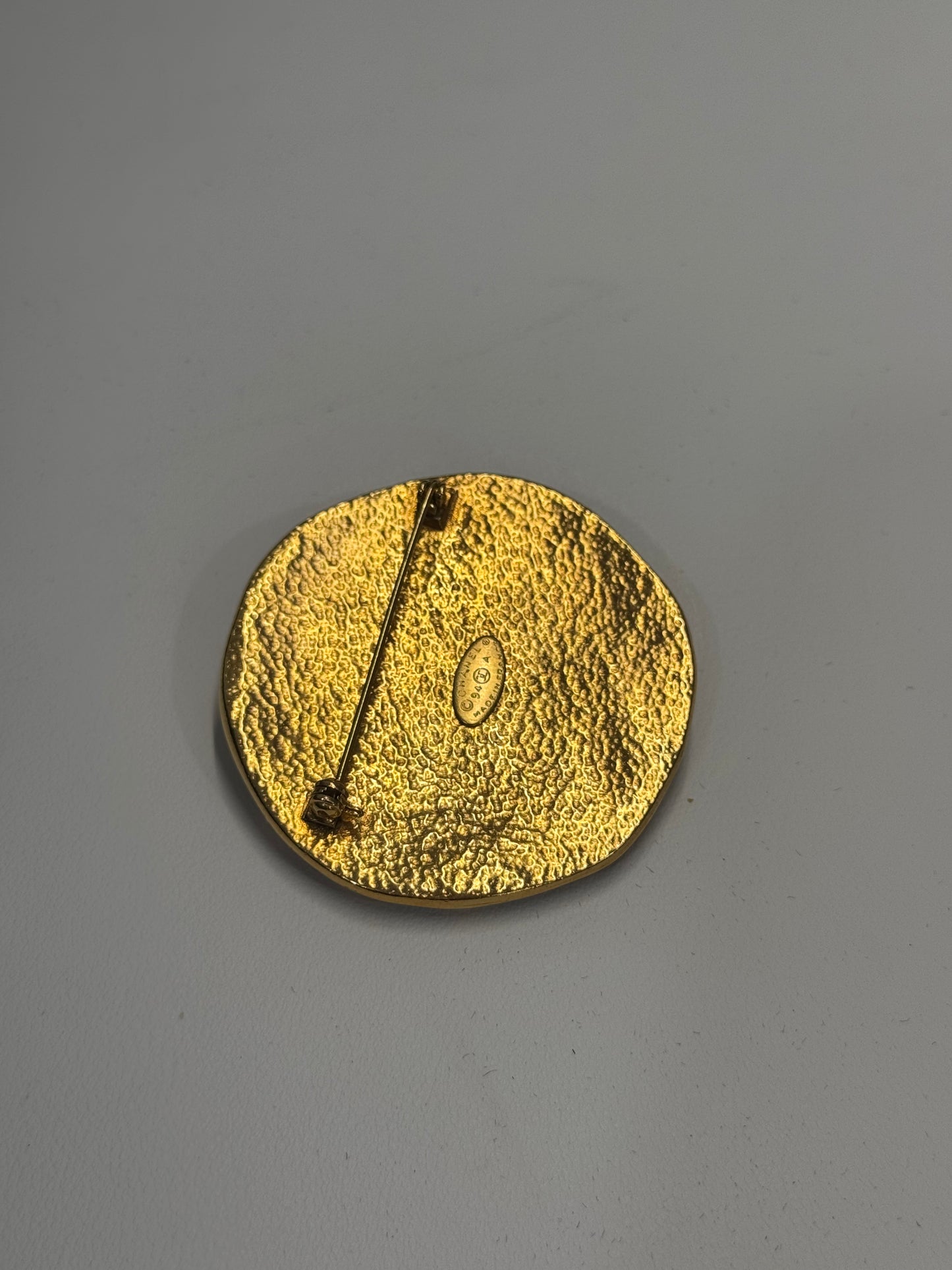 Chanel sun brooch