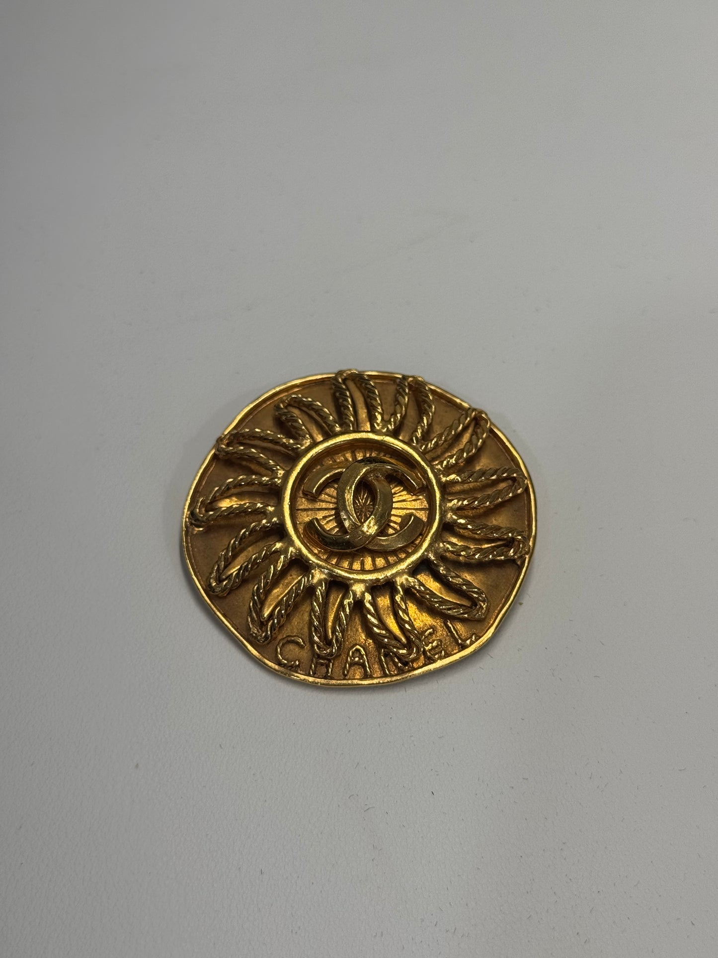 Chanel sun brooch